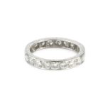 A diamond full hoop ring, grain set throughout with round brilliant-cut diamonds, the white precious