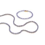 A collection of tanzanite jewellery, comprising a necklace and bracelet suite, each with a line of