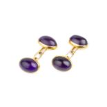 A pair of amethyst cufflinks, each with a pair of oval cabochon amethysts in closed-back collet