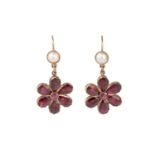 A pair of garnet and half pearl ear pendants, each suspending a flowerhead cluster of circular and