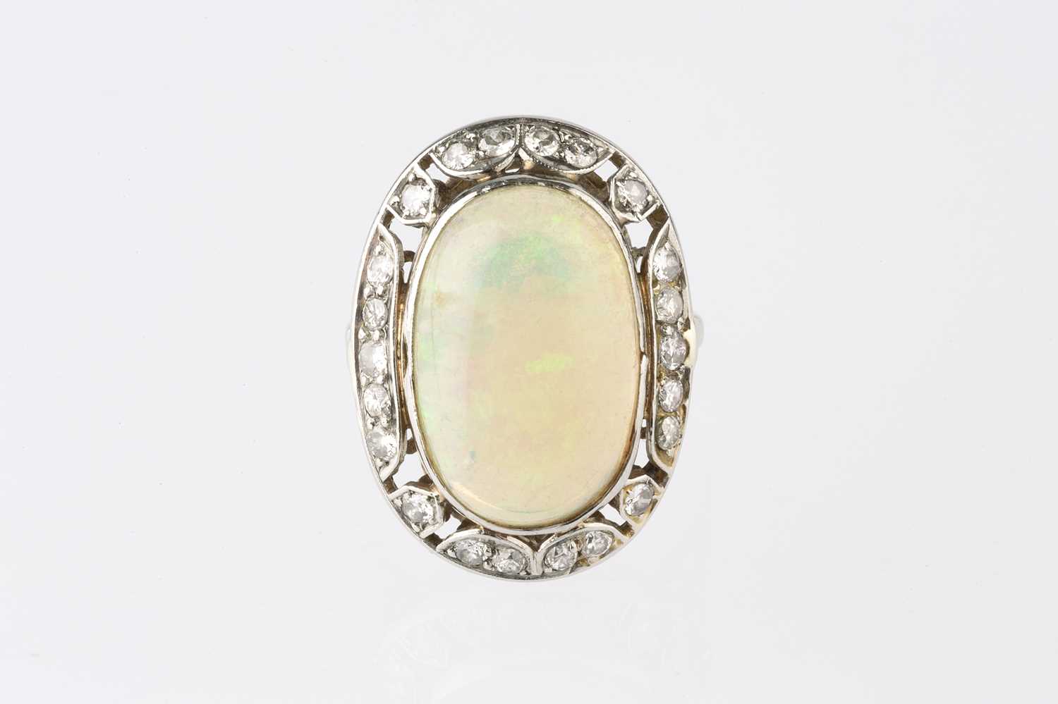 An opal and diamond cluster ring, the oval cabochon opal in collet setting, within an openwork - Image 2 of 10