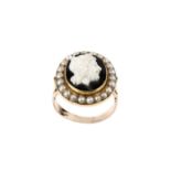 A cameo and half pearl cluster ring, the oval hardstone cameo carved to depict a classical male