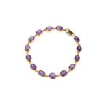 An amethyst line bracelet, designed as a series of oval mixed-cut amethysts in collet settings,