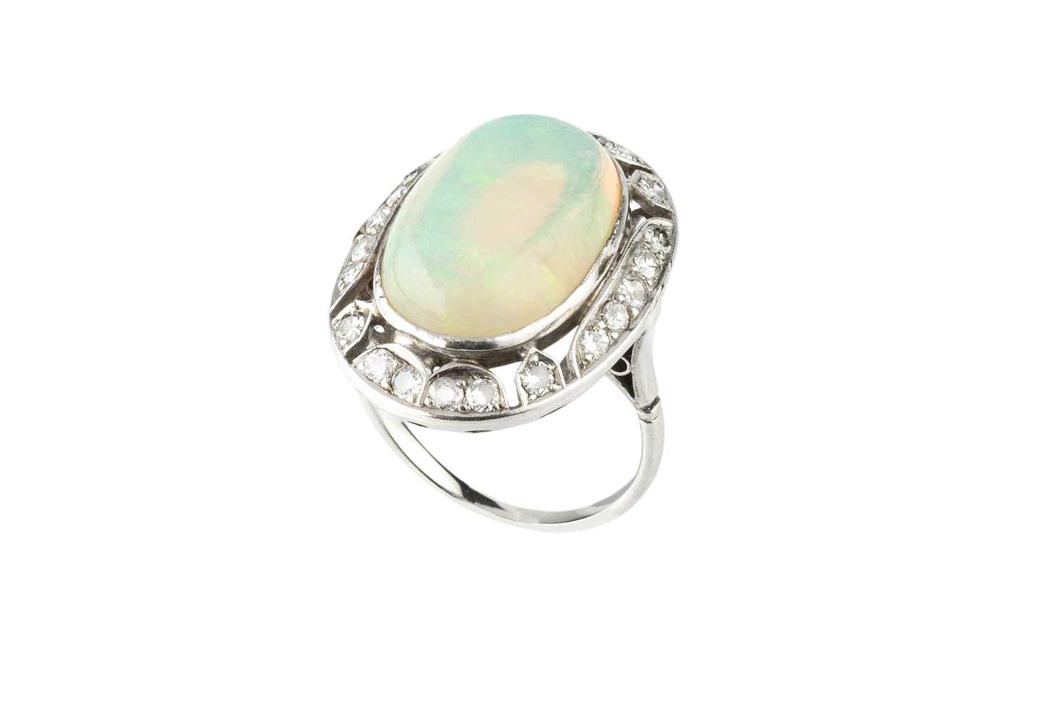 An opal and diamond cluster ring, the oval cabochon opal in collet setting, within an openwork