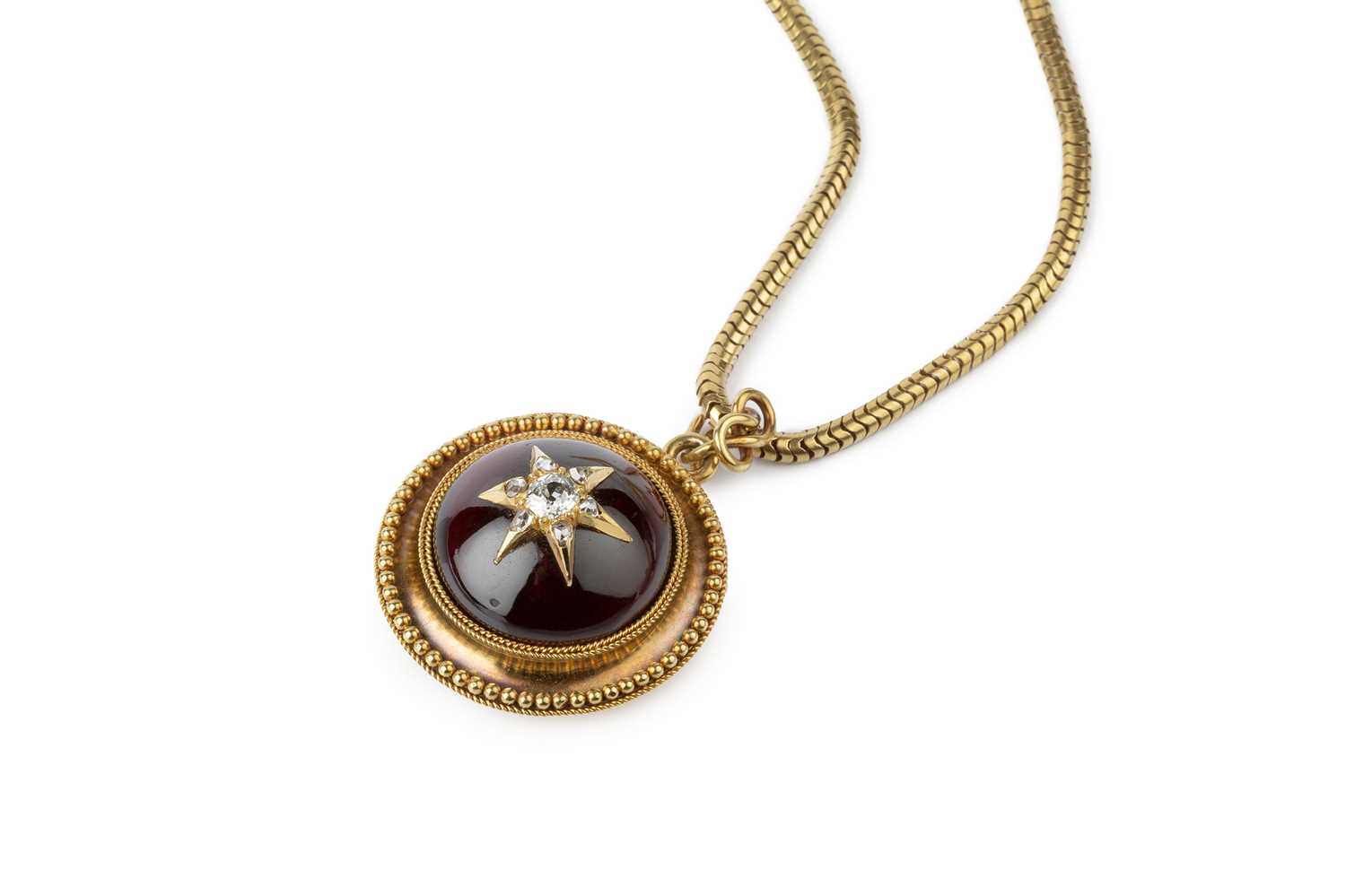 A Victorian garnet and diamond locket pendant on chain, the circular pendant centred with a cabochon - Image 3 of 5