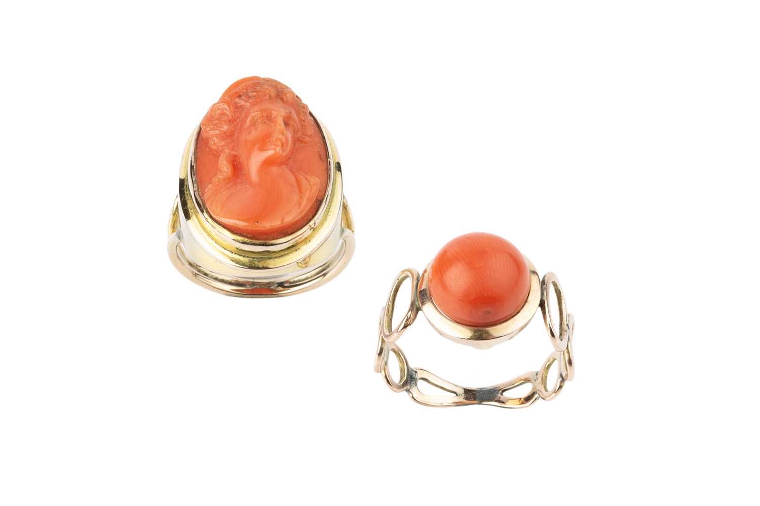 Two coral dress rings, the first a cameo ring, the oval coral corallium rubrum cameo carved to