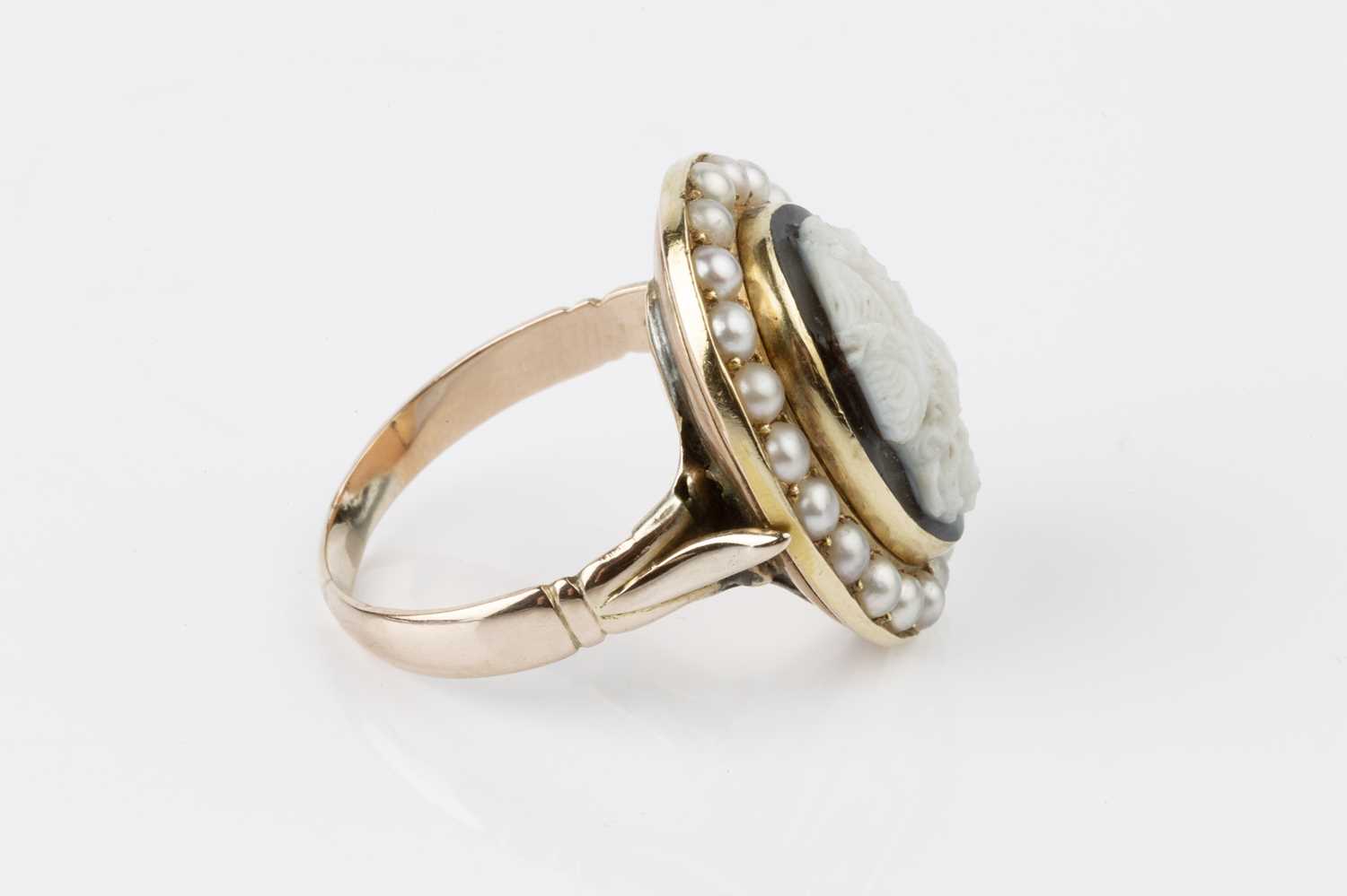 A cameo and half pearl cluster ring, the oval hardstone cameo carved to depict a classical male - Image 2 of 3