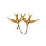 A late Victorian/Edwardian swallows brooch, modelled as two swallows in flight, each with feather