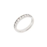 A diamond half hoop ring, channel set with a line of round brilliant-cut diamonds, platinum mounted,