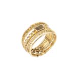 A puzzle ring, designed as seven entwined bands of beaded, reeded, fluted and plain design, the