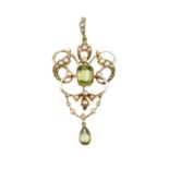 An early 20th century enamel and peridot pendant, the openwork scrolled cartouche centred with an