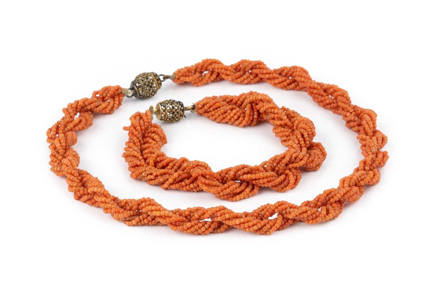 A coral bead torsade necklace and bracelet suite, designed as twisted multi-strands of coral