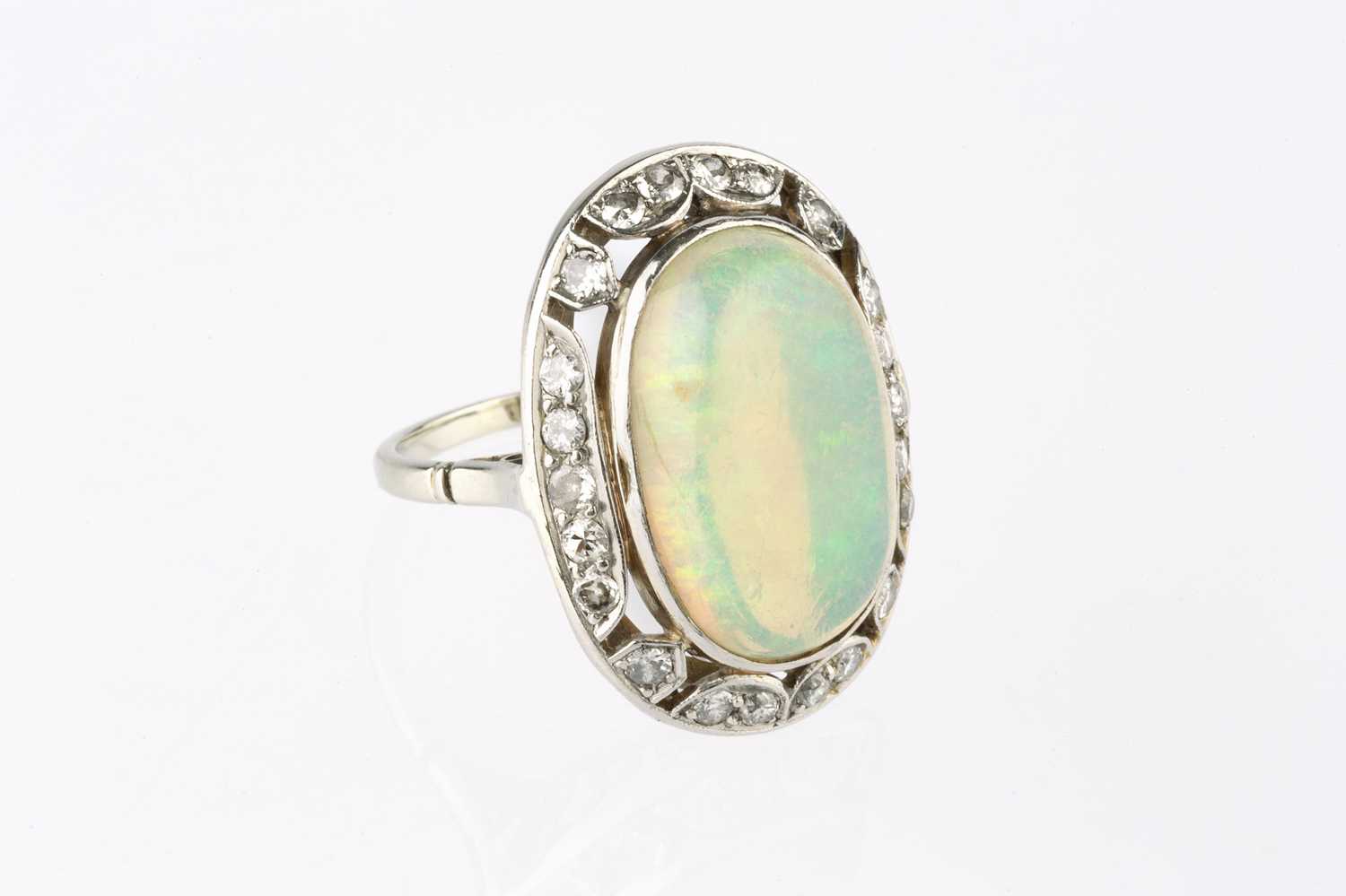 An opal and diamond cluster ring, the oval cabochon opal in collet setting, within an openwork - Image 3 of 10