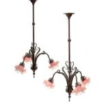 Art Nouveau A pair of hanging wall lights scrolled metal frames with pink shades 95cm high.One of