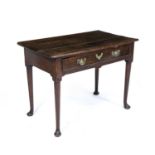 An 18th century oak side table with a single frieze drawer, brass swan neck handles, turned tapering