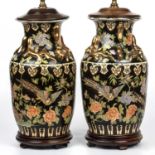 A pair of early 20th century Chinese famille noire vase lamps decorated with gilded dragons and