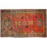 A Turkish red and green ground rug 125cm x 215cm.Discolouration to one end canvase repairs to ends