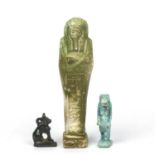 Two Egyptian amulets 3.5cm and 2.5cm together with an Egyptian shabti 9cm high. (3)