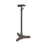 A 19th century painted cast iron adjustable torchere with a gilt metal platform, fluted stem and a