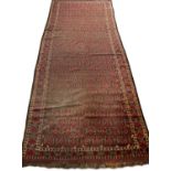 An antique Beshir with a red ground and extensive geometric decoration, 218cm x 520cmExtensive