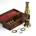 A 19th century brass drum microscope with four objectives in a fitted mahogany box, 20.5cm in