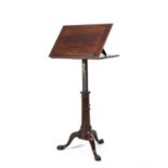 A George III mahogany architect's table with a hinged top, adjustable height, turned stem and tripod