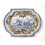 A 19th century French tin glazed platter with a central figural scene and a polychrome border,
