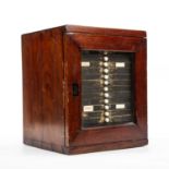 A Victorian stained pine microscope slide case with a glazed door 14 drawers and approx 17 slides