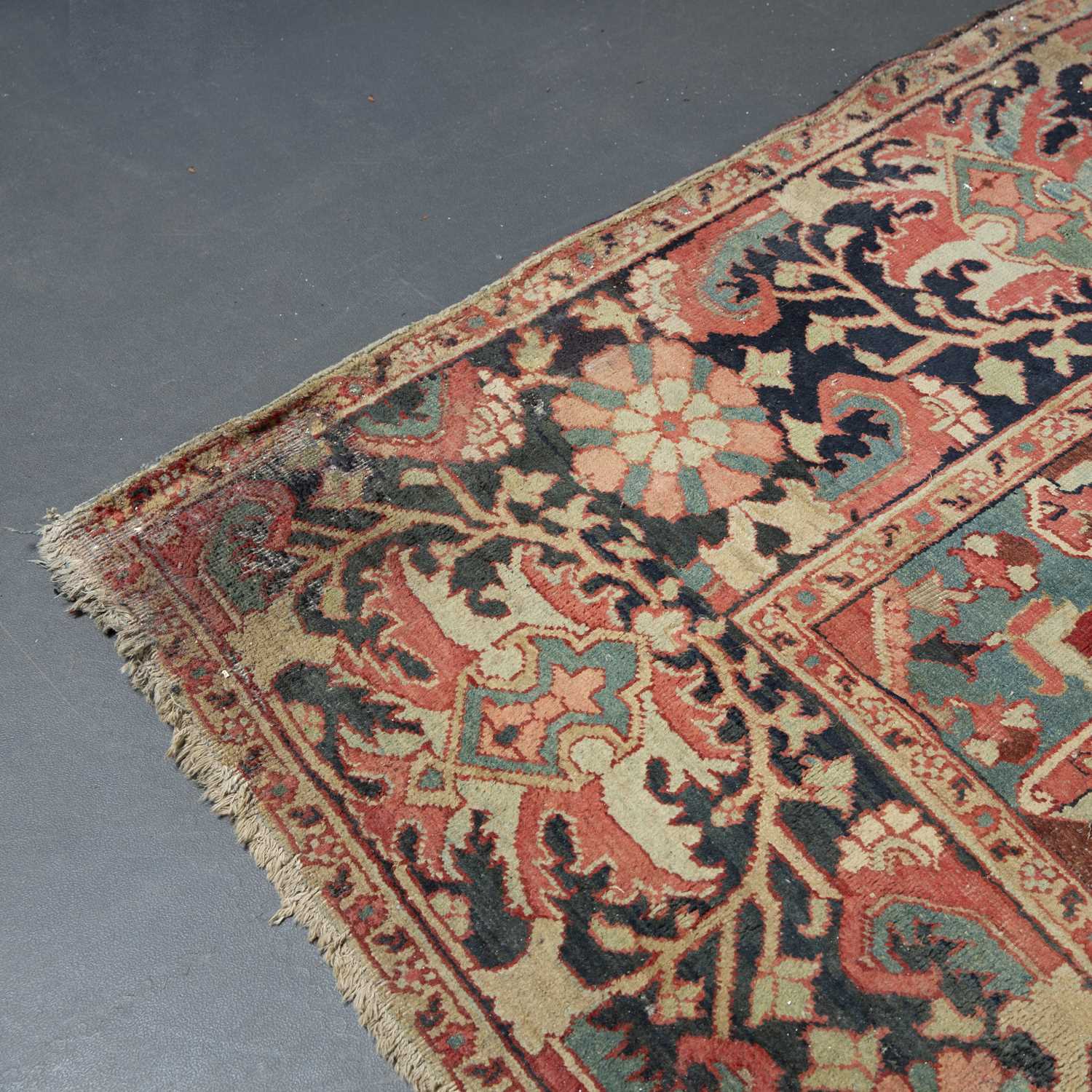 An antique Heriz red ground carpet with geometric decoration 312cm x 412cm old moth damage, - Image 3 of 6