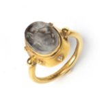 A Sasanian style rock crystal intaglio carved with a rabbit and mounted in a yellow metal ring,