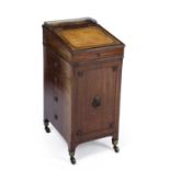 A George III Sheraton mahogany davenport of small proportions, with a leather inset sloping top,