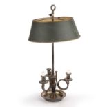 A 19th century French silver plate and Toleware bouillotte lamp with an adjustable shade and a three