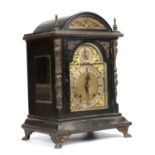 A late 19th century ebonised bracket clock the silvered dial with Arabic and Roman numerals