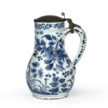 A 17th century Dutch Delft blue and white tankard decorated with a peacock and butterfly, circa