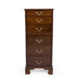 A 19th century mahogany tall chest of six drawers with a central slide and brass handles raised on