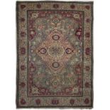 An antique Persian red and blue ground rug with foliate decoration. 138cm x 195cmModerate wear, some