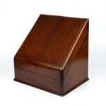 An early Victorian mahogany stationery box with folding doors opening to reveal pigeon holes and