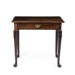 A Georgian mahogany side table with a single frieze drawer, brass swan neck handle, turned