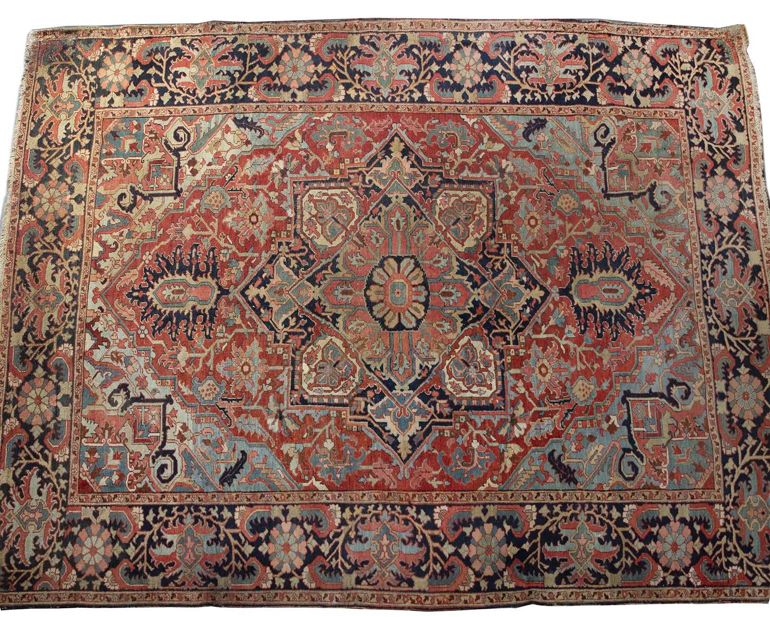 An antique Heriz red ground carpet with geometric decoration 312cm x 412cm old moth damage,