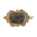 A Sasanian style rock crystal intaglio carved with an animal and mounted in a yellow metal ring, the