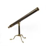 A 19th century brass refracting telescope by Horne, Thornthwaite and Wood, mounted on a tripod.