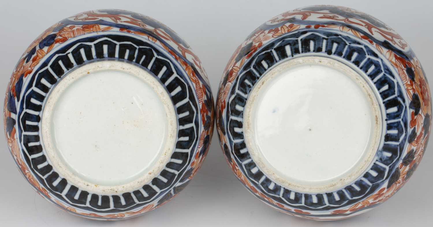 A pair of late 19th century Japanese Imari bottle vases with covers, 15cm wide 27cm high.Good, minor - Image 3 of 4