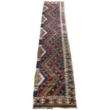 An antique Kilim runner with purple, green and blue zigzag decoration, 81cm x 330cmSeveral small
