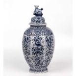 An antique Dutch Delft blue and white vase and cover of octagonal form with a leopard finial and
