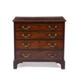 A George III mahogany chest of four long drawers with brass swan neck handles, a brushing slide