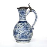 A Dutch delft blue and white jug with a pewter cover and looping handle Circa 1700, 13cm wide 22cm