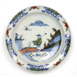 An early 18th century Dutch Delft charger with Chinese decoration circa 1720, 35cm diameterRivited