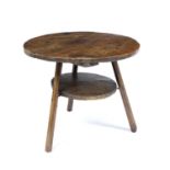 An 18th century country made oak and elm cricket table 66cm diameter 60cm high.Surface worm holes,