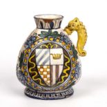 An antique Italian majolica vase decorated with a crest and a portrait, having a dolphin handle (one
