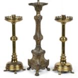 A pair of ecclesiastical brass candlesticks converted to lamps, overall 61cm high together with an
